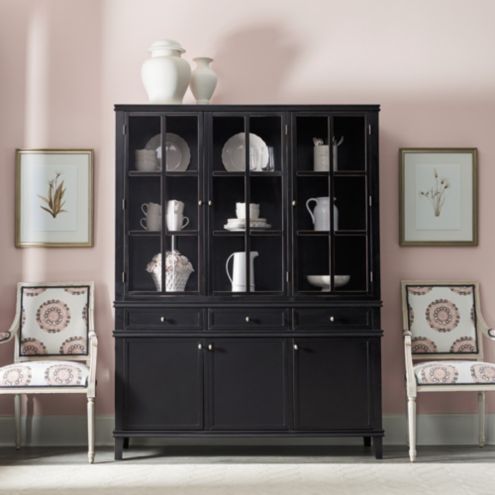 Black wooden sideboard and hutch in a decorated room setting.